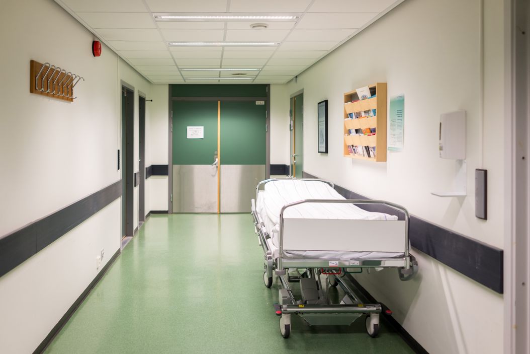 Bed in hospital corridor