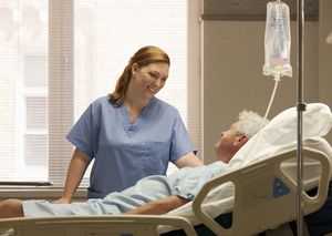 Female nurse with male patient in hospital